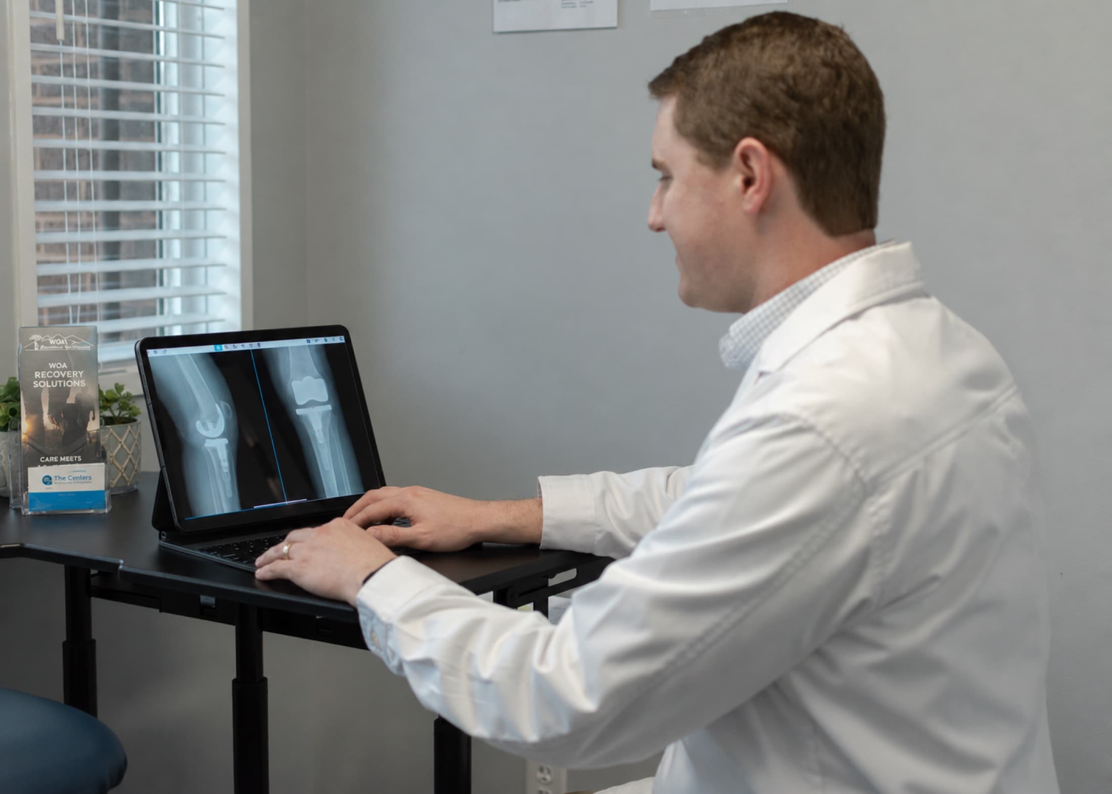Dr. Seem reviewing joint X-rays before surgery